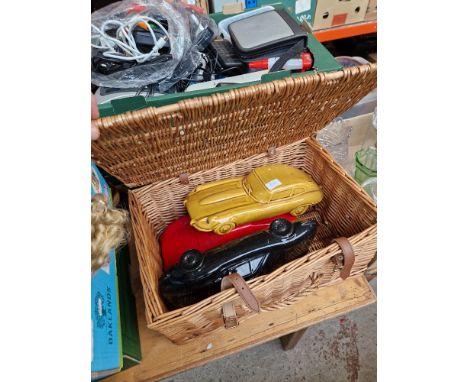 An F&amp;M wicker hamper with 3 ceramic Ferraris 