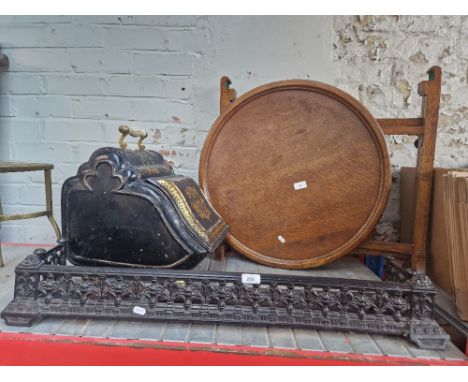 A mixed lot comprising Victorian cast iron fire curb, Victorian toleware coal scuttle, cast iron shovel and an oak folding fi