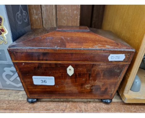 A George III inlaid mahogany tea caddy. 