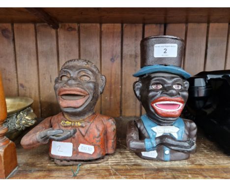 Two cast metal money banks.Note:- These items are listed on the basis they are illustrative of a bygone culture in which ther