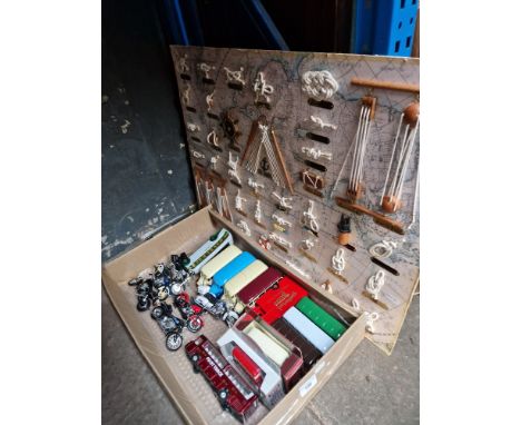 A box of assorted model vehicles and a knot display. 