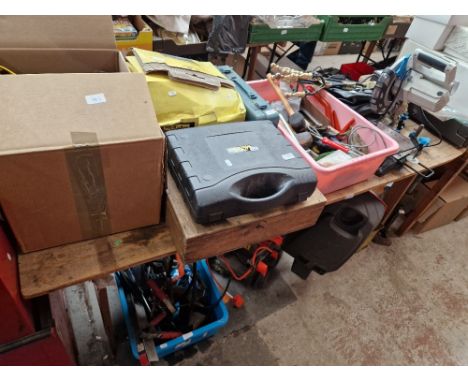 A table top and below comprising briefcase and fire tidy, MacAllister compound mitre saw, box of hand tools, McKeller cordles