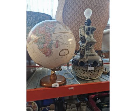 A Herff Jones globe on a stand and a ceramic table lamp 