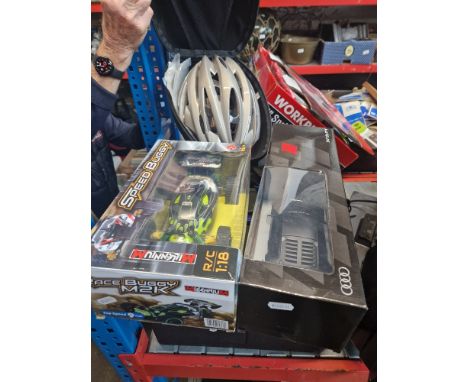 A toolbox with tools, 2 remote control cars &amp; a Boardman cycle helmet in case.