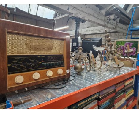 Two brass ceiling light fittings, a glass chandelier and a vintage radio.
