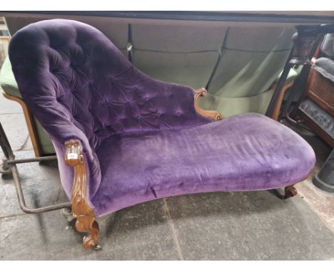 A Victorian carved walnut and button back chaise longue. 