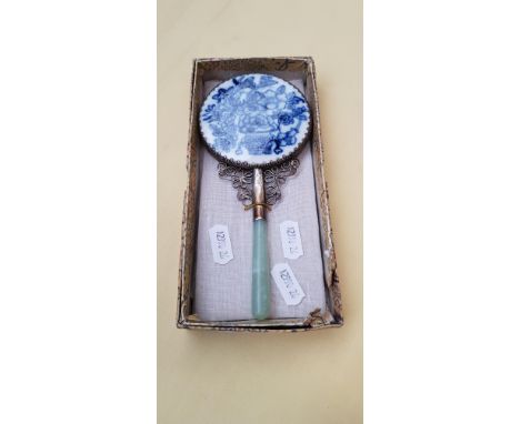 A vintage Chinese hand mirror with ceramic back and jade handle. 