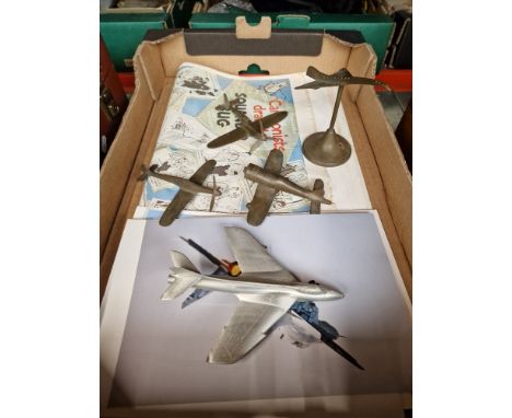 A small collection of repro wartime posters, photographs of military aircraft, and number of possibly home made metal model a