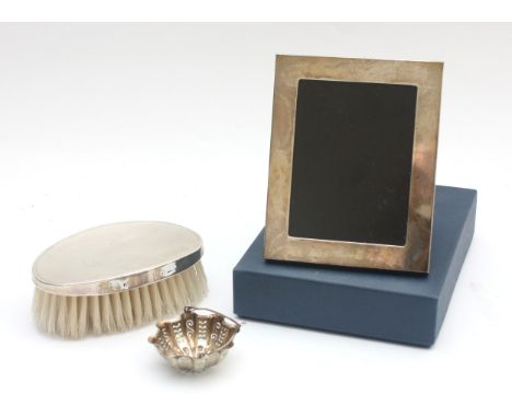 A silver clothes brush, Birmingham 1985, together with a 925 silver photograph frame, Birmingham 2006, and a silver tea strai