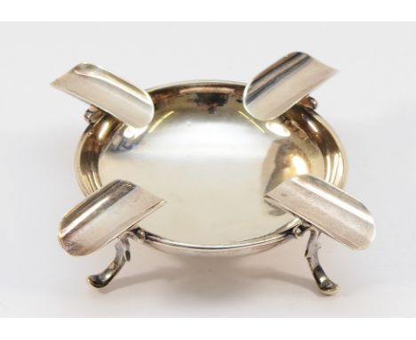 A silver ashtray by Mappin &amp; Webb, Birmingham 1905, raised of four scroll feet, 4.5x4cm, 105gm.