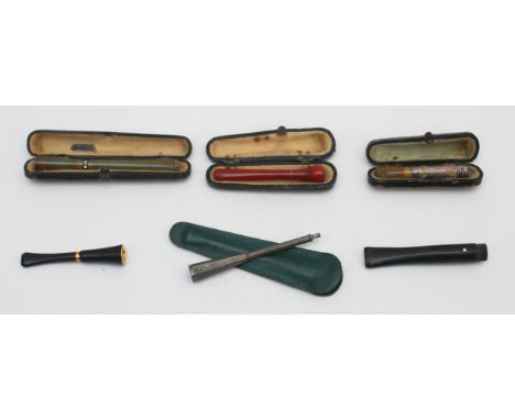 Dunhill, a silver cigarette holder, by Alfred Dunhill, Birmingham, probably 1960, no mouth piece and five other cigarette hol