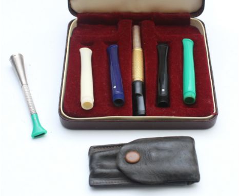 Dunhill, four white spot cigarette holders, case,  a white spot with gilt holder, a silver a white spot cigarette holder, by 