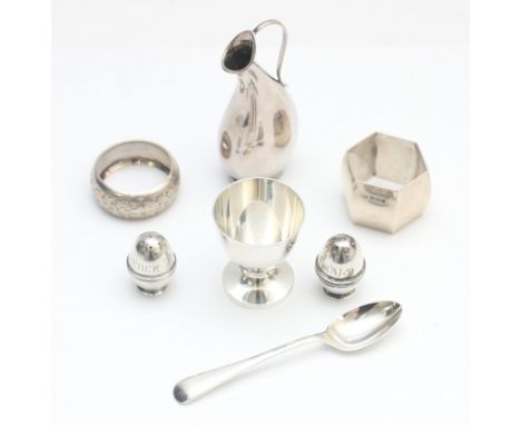 A silver egg cup and spoon, Sheffield 1964, two silver napkin rings, a Scandiavian silver curved pitcher and a pair of 830 sa