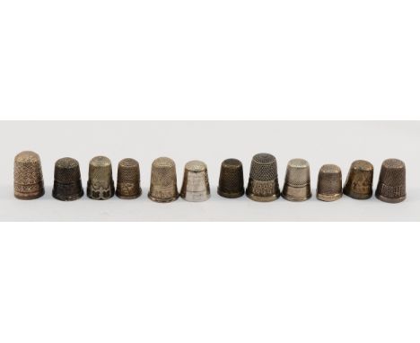 A silver thimble, Chester 1913, together with seven other silver thimbles, three sterling and one unmarked, 49gm.