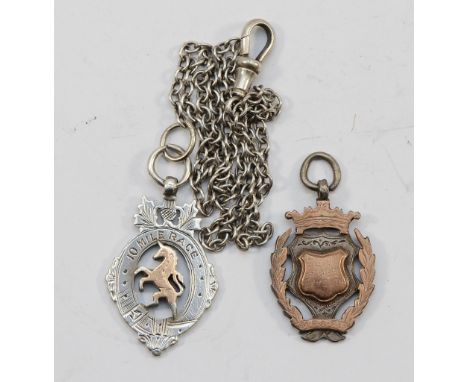 A silver presentation watch fob, 1907, together with another silver fob, Birmingham 1909, 30gm.