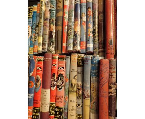 Shelf of childrens books mostly with dust covers including Enid Blyton