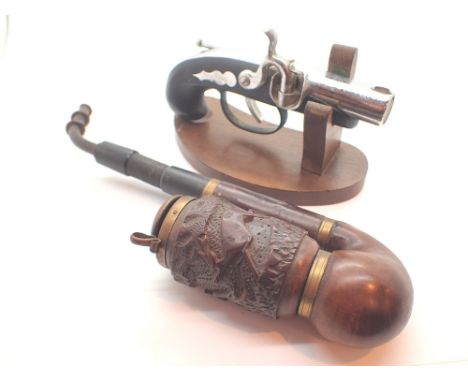 Small table lighter in the form of flintlock pistol with a heavily carved Black Forest Swiss pipe