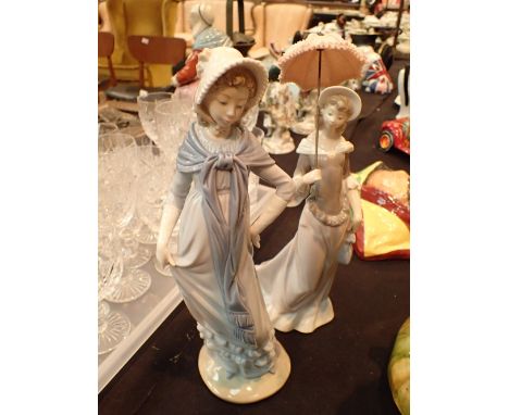 One Lladro lady figurine with parasol and a Nao lady figurine H: 40 cm