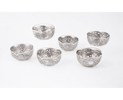 A set of six Chinese silver pierced bowls, late 19th-early 20th century, comprising three pairs decorated with dragons flower