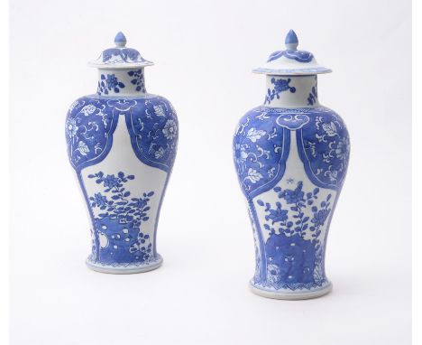 Two similar Chinese 'Shipwreck' blue and white vases and covers, Kangxi, painted with panels of flowers and pierced rocks, 26