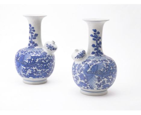 A pair of Chinese blue and white 'Shipwreck' kendi, Kangxi, painted with a phoenix on each side amongst flowers, 23cm high (2