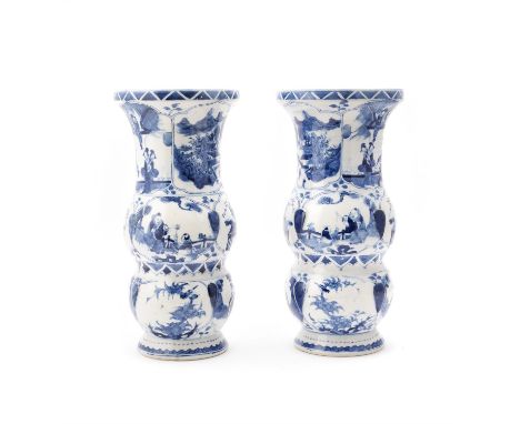 A pair of Chinese blue and white double gourd vases, Qing Dynasty, 19th century, painted panels of scenes of families, birds 