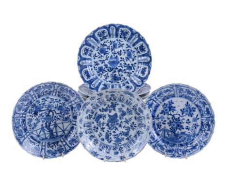Seven Chinese blue and white plates, Kangxi, comprising: four similar plates, with central chrysanthemum within lappet border