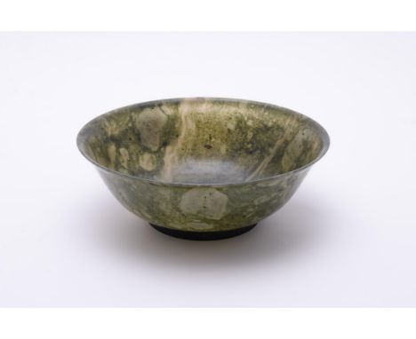A Chinese spinach jade bowl, raised on a short foot with gently flaring sides, 16cm diameterProvenance: Private English Colle