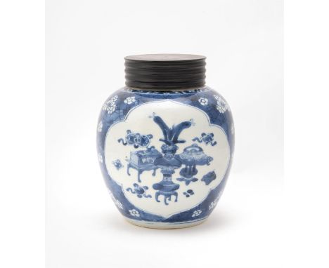 A Chinese blue and white ginger jar and cover, Kangxi, painted with two panels of precious vessels on a 'cracked-ice' and 'bl