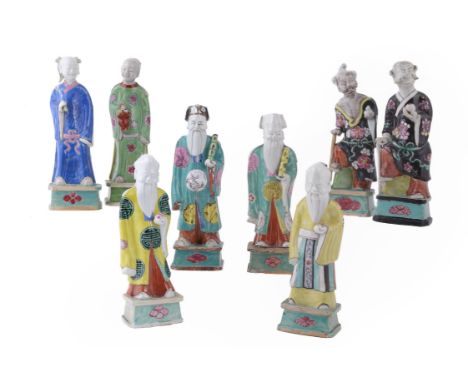 A collection of eight famille rose standing immortals, Qianlong period (1736-1795), each holding their attribute, wearing bri