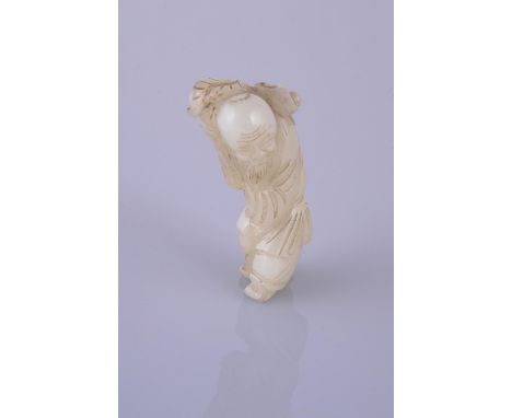 A Chinese celadon jade figure of Shoulao, 19th century, the God of Longevity carved standing wearing long robes, holding a st
