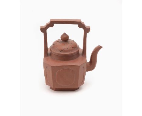 A Chinese Yixing teapot and cover, the square-sectioned body with upright handle and roof formed terminal, the base inscribed