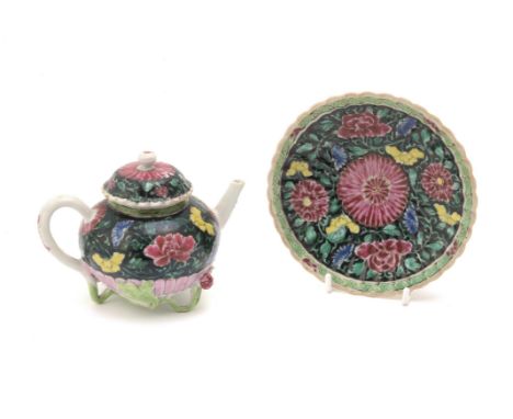 A Chinese 'Famille Noire' teapot, cover and stand, Yongzheng, decorated with scrolling flowers and foliage, teapot 15cm wide 