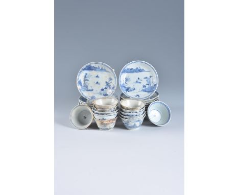 Seventeen Ca Mau 'fisherman' pattern blue and white saucers and twelve tea bowls, circa 1725, with a lone fisherman at the wa