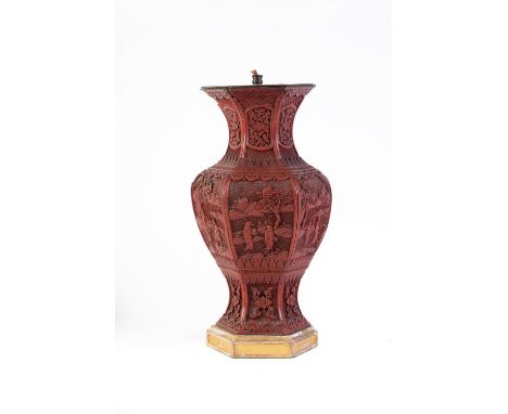 A Chinese cinnabar lacquer hexagonal vase, Qing Dynasty, 19th century, each side carved with scholars in gardens between form