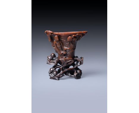 Y A rare Chinese rhinoceros horn 'Scholar' libation cup, 17th-18th century, the well-polished small cup of warm amber tone, c