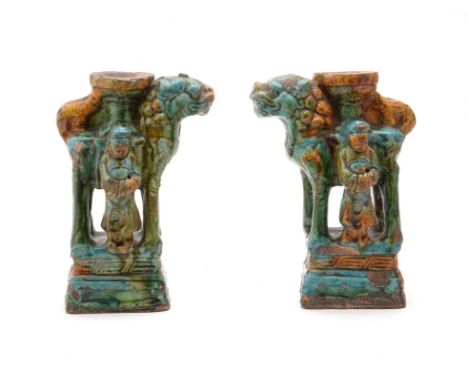 A pair of Chinese pottery Sancai glazed joss stick holders, probably 17th century, the two lions facing to the left and right