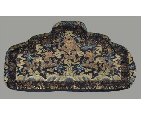 A rare Chinese throne cushion, Kangxi, circa 1700, of deep blue silk woven with three five clawed gold thread dragons among c