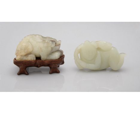 A Chinese celadon and russet jade 'Boy and fungus' carving, the boy crawling on all fours, carrying a spray of a lingzhi fung