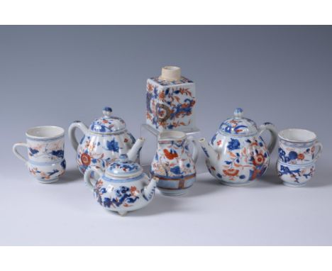 Three Chinese Imari teapots and covers, Kangxi (1662-1722), comprising a pair of lobed ovoid teapots, 11.5cm high, and a flat