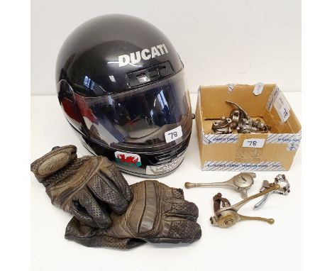 A Ducati dual fibreglass helmet, XL 61/62 1250, with a Ducati coth bag/cover, and a group of handlebar levers 