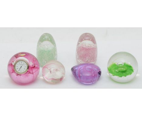 Caithness, four glass paperweights to include 'sentinel','true hearts', 'moon crystal', one set with a clock, and two other e