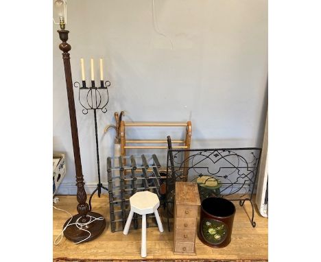 A collection of homewares, to include a turned wood standard lamp, a wrought iron candlestick stand, a wine rack, fireguard, 