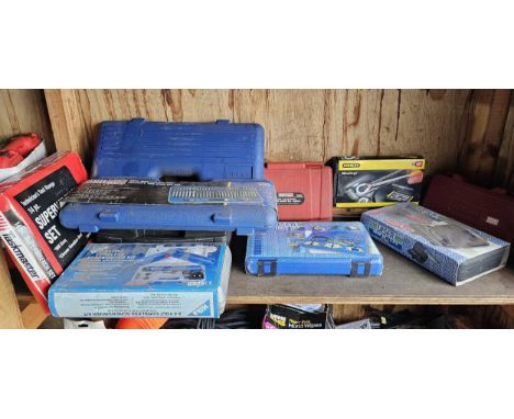 A collection of cased unused tools, including Sealey.