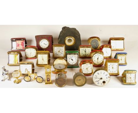 A collection of miniature novelty clocks, together with a quantity of traveling alarm clocks, having manual and quartz moveme