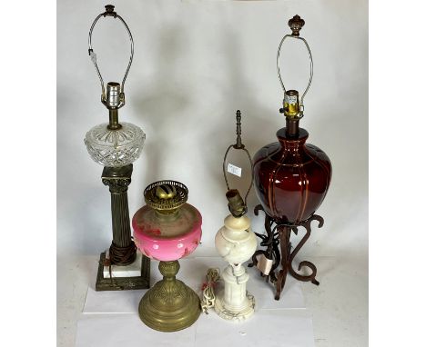 A collection of table lamps and shades, together with an Edwardian oil lamp. 