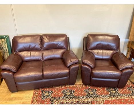 A modern brogue brown leather two seater sofa, 146 x 92cm, with a matching reclining arm chair. (2) 