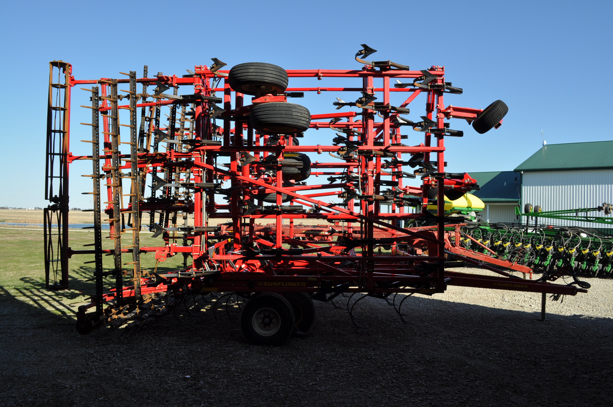 49’ Sunflower 5056 field cultivator, 3 bar spike tooth harrow, rear