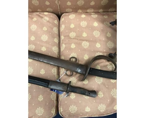 A 19TH CENTURY CAVALRY SWORD, in steel scabbard and a WWI bayonet, in leather scabbard (2)
