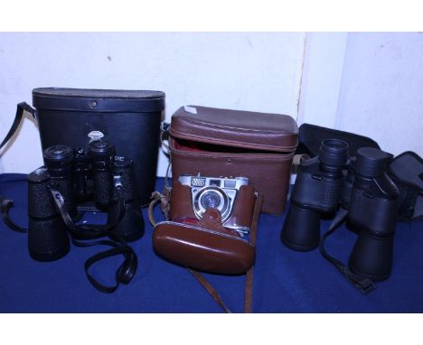 Two pairs of binoculars and a vintage Kodak camera 